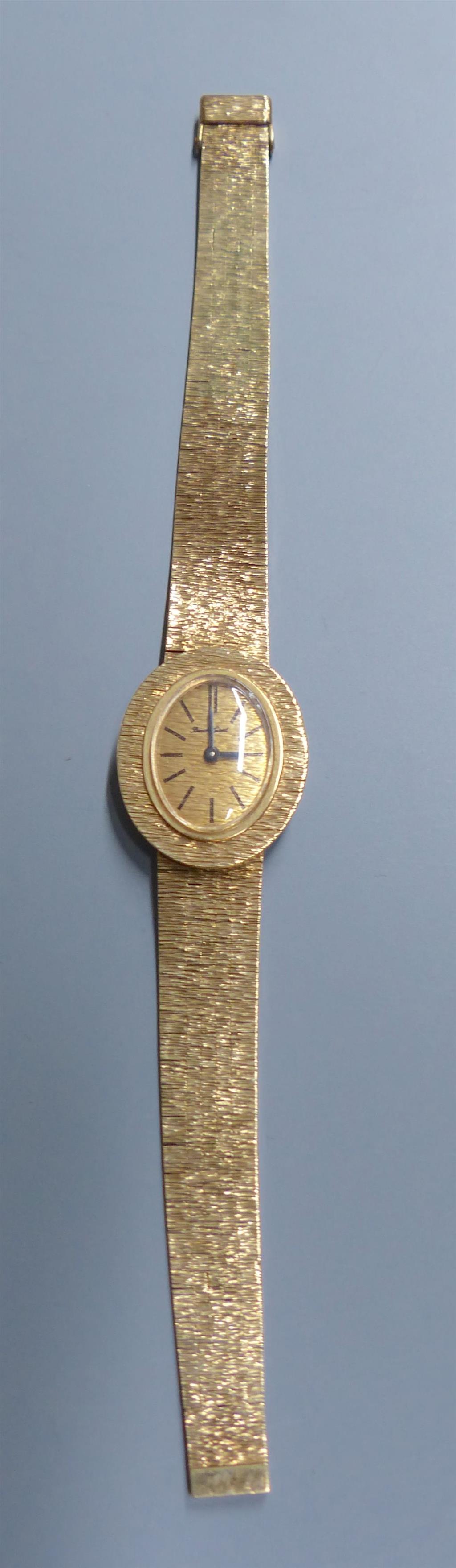 A ladys 9ct gold Bueche Girod manual wind wrist watch, on a textured 9ct gold bracelet, 15.7cm, gross 23.5 grams.